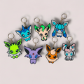 Set of colorful keychains shaped like cartoon characters on a light gray background Eevee Evolutions. 