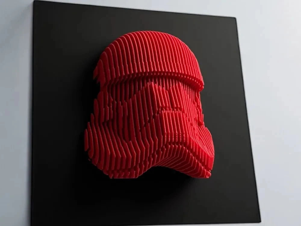 Red stormtrooper helmet sculpture on a black background