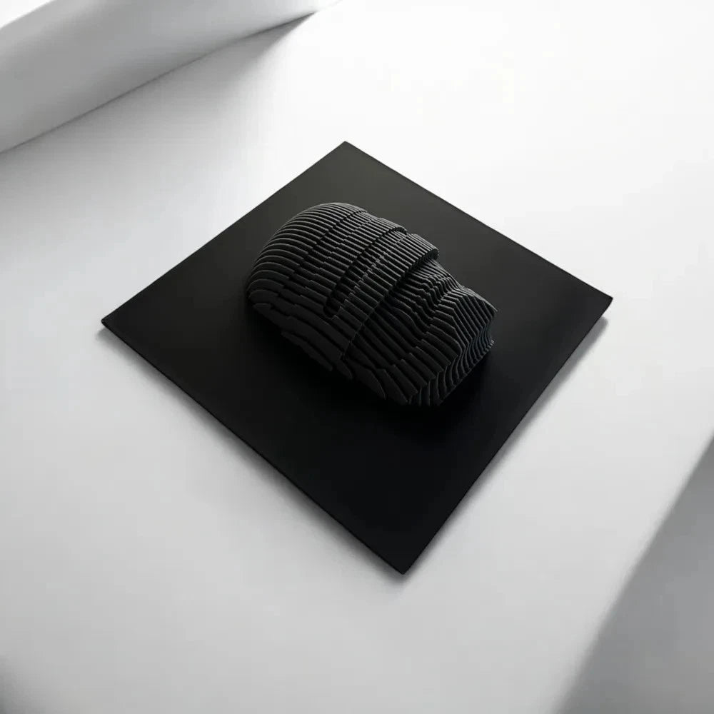 Robocop Black textured object on a black square platform with a white background