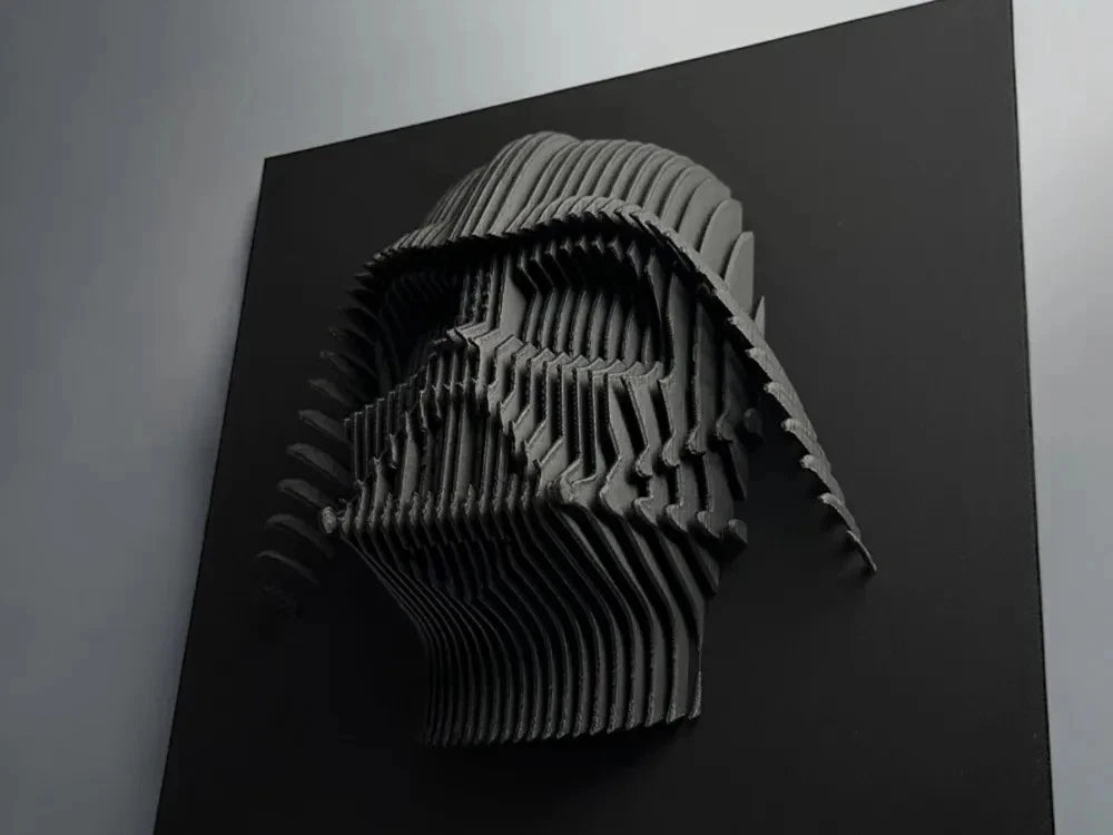 Darth Vader 3D paper sculpture of a helmet on a black background